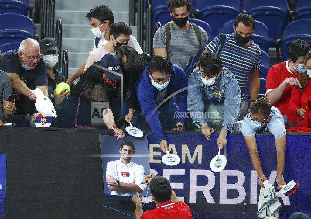 Hamish Blair Serbia's Novak Djokovic signs autographs after defeating Germany's Alexander Zverev in their ATP Cup match in Melbourne, Australia, Friday, Feb. 5, 2021.(AP Photo/Hamish Blair)