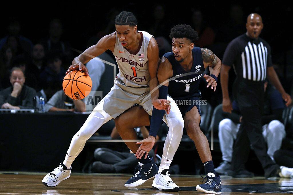 Adam Hunger Virginia Tech's David N'Guessan (1) keeps the ball away from Xavier's Paul Scruggs during the first half of an NCAA college basketball game in the NIT Season Tip-Off tournament Friday, Nov. 26, 2021, in New York. (AP Photo/Adam Hunger)