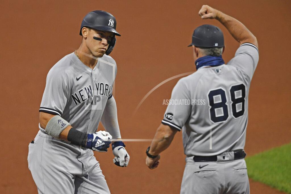 David Dermer New York Yankees' Aaron Judge (99) is congratulated by Phil Nevin (88) after hitting a two run home run off Cleveland Indians starting pitcher Shane Bieber (57) in the first inning of Game 1 of an American League wild-card baseball series, Tuesday, Sept. 29, 2020, in Cleveland. (AP Photo/David Dermer)