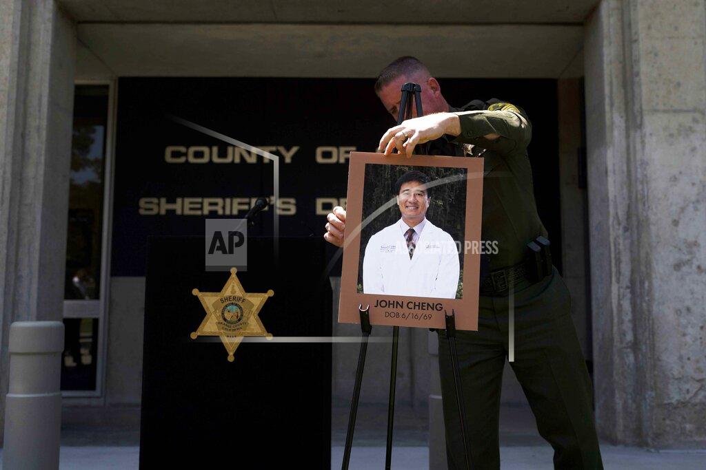 Jae C. Hong FILE - Orange County Sheriff's Sgt. Scott Steinle displays a photo of Dr. John Cheng, a 52-year-old victim who was killed in Sunday's shooting at Geneva Presbyterian Church, before a news conference in Santa Ana, Calif., Monday, May 16, 2022. After a weekend of gun violence in America, when shootings killed and wounded people grocery shopping, going to church and simply living their lives, the nation marked a milestone of 1 million deaths from COVID-19. The number, once unthinkable, is now a pedestrian reality in the United States, just as is the reality of the continuing epidemic of gun violence that kills tens of thousands of people a year. (AP Photo/Jae C. Hong, File)