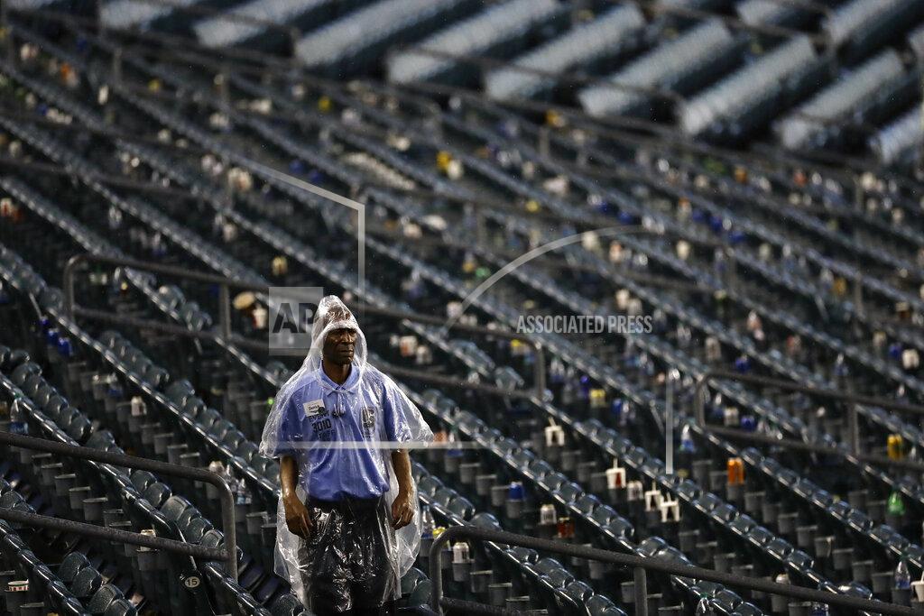 Michael Perez A worker walks through the stands as a storm ends a preseason NFL football game between the Philadelphia Eagles and the Baltimore Ravens, Thursday, Aug. 22, 2019, in Philadelphia. (AP Photo/Michael Perez)