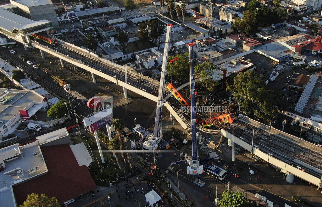 Fernando Llano An aerial view of subway cars dangle at an angle from a collapsed elevated section of the metro, in Mexico City, Tuesday, May 4, 2021. The elevated section of Mexico City's metro collapsed late Monday killing at least 23 people and injuring at least 79, city officials said. (AP Photo/Fernando Llano)