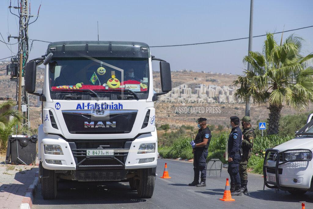 Nasser Nasser A Palestinian security unit mans a checkpoint at an entrance of in the West Bank city of Ramallah, Thursday, July 2, 2020. The Palestinian Authority has announced a five-day total lockdown in the West Bank starting Friday, in response to a major increase in coronavirus cases and deaths in recent days. (AP Photo/Nasser Nasser)
