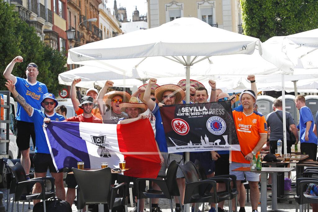 Angel Fernandez Glasgow Rangers supporters cheer outside a bar in downtown Seville, Spain, Tuesday, May 17, 2022. Eintracht Frankfurt will play Glasgow Rangers in the Europa League final Wednesday evening in Seville. (AP Photo/Angel Fernandez)