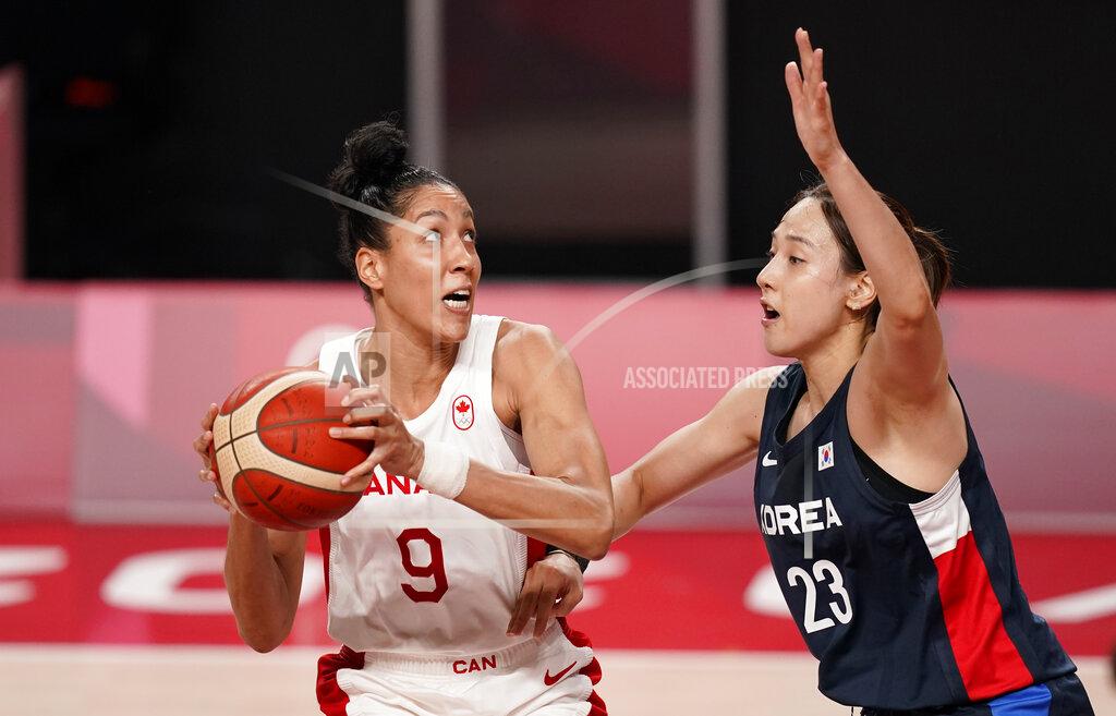 Charlie Neibergall Canada's Miranda Ayim (9), left, drives to the basket past South Korea's Danbi Kim (23) during women's basketball preliminary round game at the 2020 Summer Olympics, Thursday, July 29, 2021, in Saitama, Japan. (AP Photo/Charlie Neibergall)