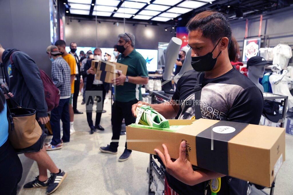 Kamran Jebreili A customer examines his Superstar Ravi sneaker at the Adidas showroom in Dubai, United Arab Emirates, Thursday, June 23, 2022. Adidas has teamed up with Dubai nostalgic family-owned Pakistani restaurant to release the Superstar Ravi sneaker. (AP Photo/Kamran Jebreili)