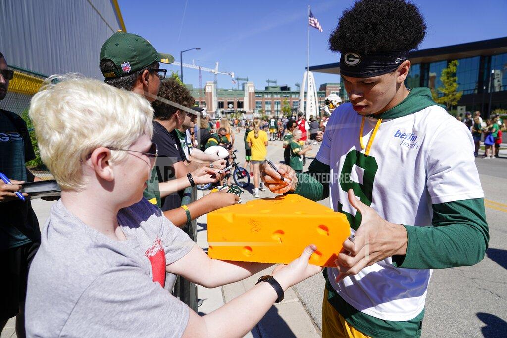 Morry Gash Green Bay Packers' Christian Watson signs an autograph at the team's NFL practice field Saturday, July 30, 2022, in Green Bay, Wis. (AP Photo/Morry Gash)