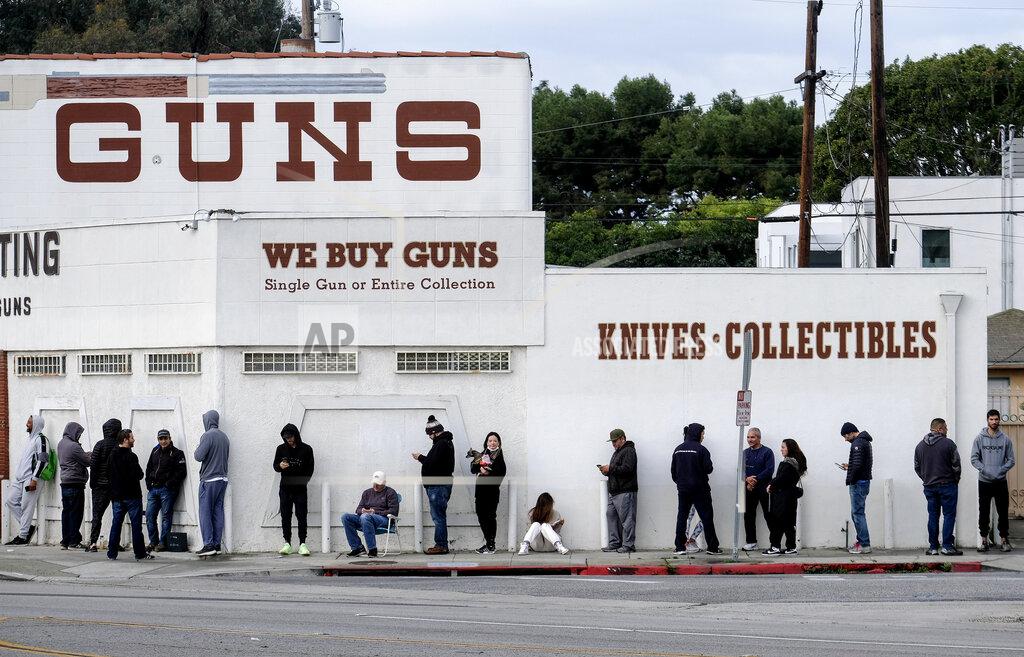 Ringo H.w. Chiu FILE - In this Sunday, March 15, 2020, file photo, people wait in line to enter a gun store in Culver City, Calif. After a year of pandemic lockdowns, mass shootings are back, but the guns never went away. As the U.S. inches toward a post-pandemic future, guns are arguably more present in the American psyche and more deeply embedded in American discourse than ever before. The past year's anxiety and loss fueled a rise in gun ownership across political and socio-economic lines. (AP Photo/Ringo H.W. Chiu, File)