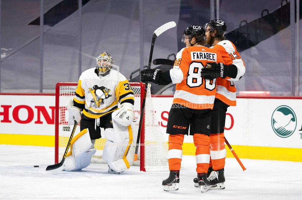 Chris Szagola Philadelphia Flyers' Joel Farabee, center, celebrates his goal on Pittsburgh Penguins' goaltender Tristan Jarry, left, with Kevin Hayes, right, during the second period of an NHL hockey game, Wednesday, Jan. 13, 2021, in Philadelphia. (AP Photo/Chris Szagola)