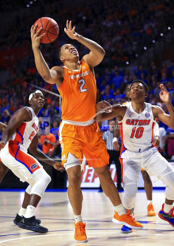 Matt Stamey Tennessee forward Grant Williams (2) shoots next to Florida guard Noah Locke (10) during the first half of an NCAA college basketball game Saturday, Jan. 12, 2019, in Gainesville, Fla. (AP Photo/Matt Stamey)