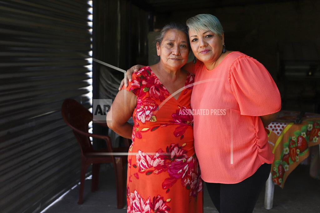 Salvador Melendez Iris Franco, right, hugs her mother, Elsa Victorina Franco, at her home, in El Ranchador, Santa Ana, El Salvador, Friday, March 5, 2021. The Salvadoran family lives humbly but is in a better place thanks to financial support from a family member in the United States who is part of the Temporary Protected Status program. (AP Photo/Salvador Melendez)