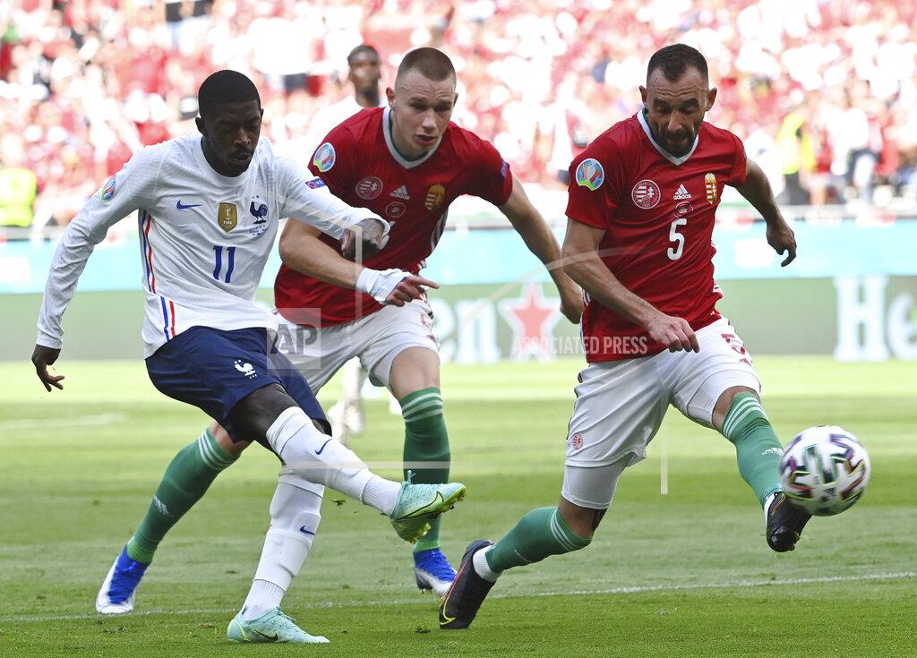 Tibor Illyes France's Ousmane Dembele, left, takes a shot during the Euro 2020 soccer championship group F match between Hungary and France at the Ferenc Puskas stadium in Budapest, Hungary Saturday, June 19, 2021. (Tibor Illyes/Pool via AP)