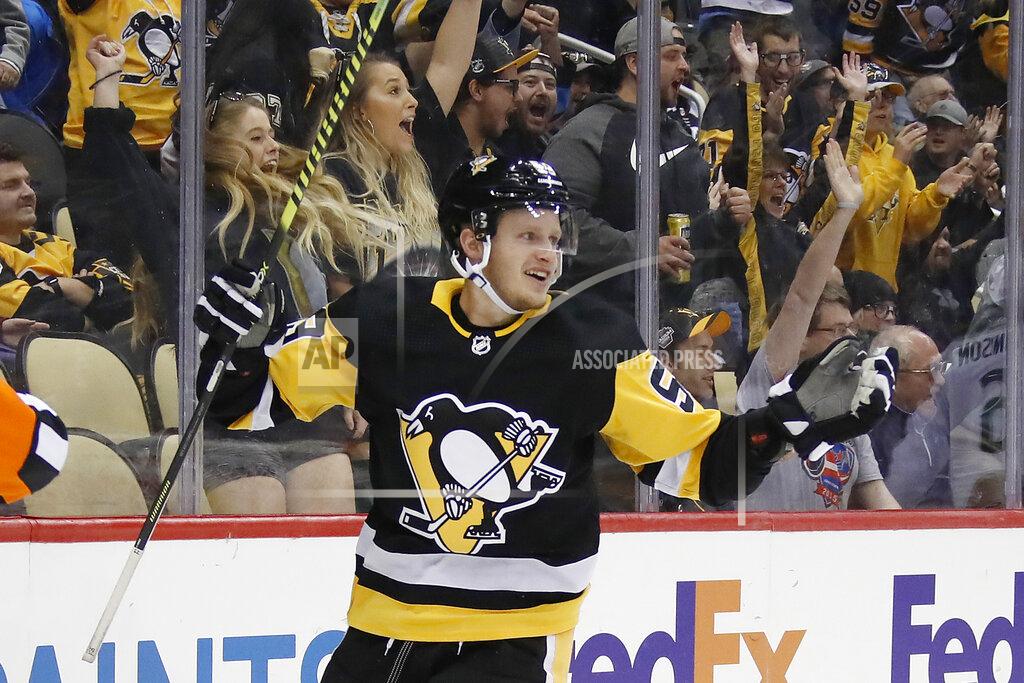Gene J. Puskar FILE - In this Oct. 16, 2019, file photo, Pittsburgh Penguins' Jake Guentzel celebrates after scoring during the second period of an NHL hockey game against the Colorado Avalanche in Pittsburgh. Guentzel feared his season was over thanks to a shoulder injury in December. The "pause" caused by the pandemic has given him renewed optimism that he will be ready when the playoffs hopefully being this summer. (AP Photo/Gene J. Puskar, File)