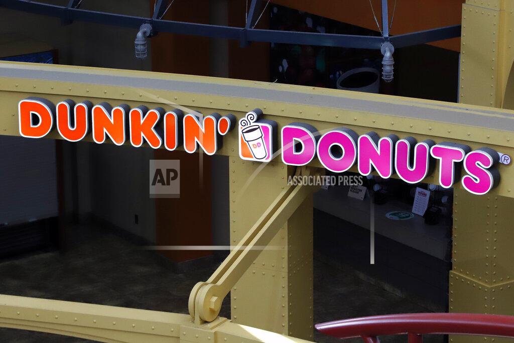 This May 7, 2020, file photo, shows a Dunkin' Donuts at the Greater Pittsburgh International Airport in Moon, Pa. The Dunkin’ doughnuts and coffee chain confirmed it's held talks to be taken private by a private equity firm, sending shares rocketing to an all-time high at the opening bell Monday, Oct. 26, 2020.(AP Photo/Gene J. Puskar, File)