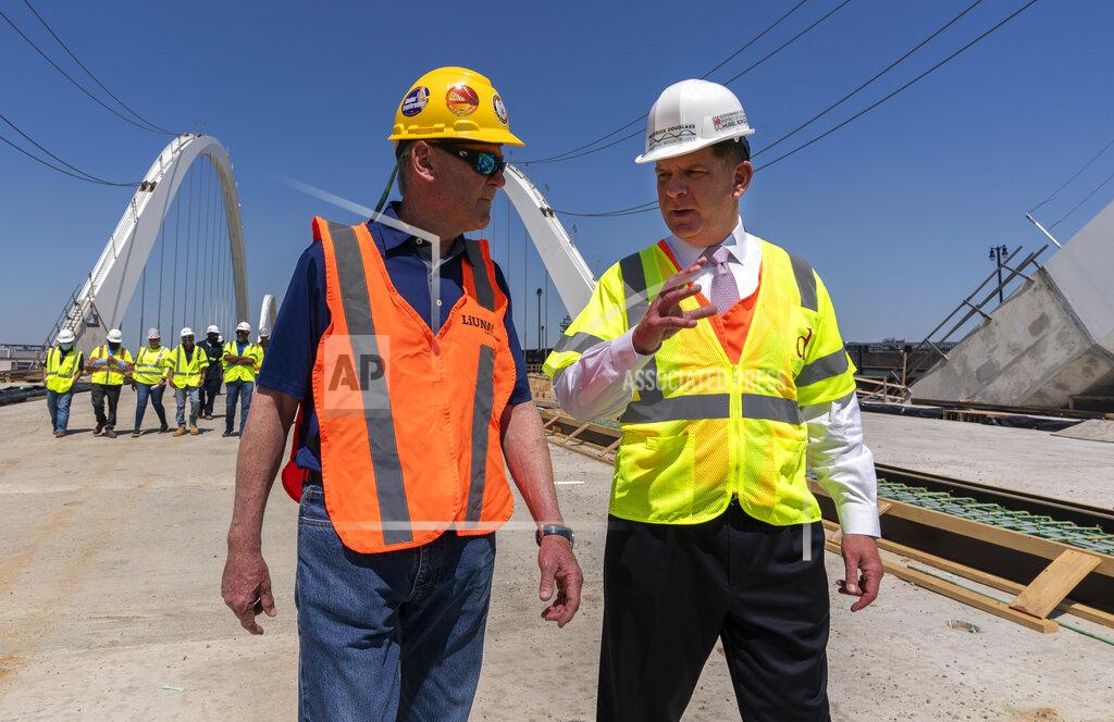 Manuel Balce Ceneta FILE - In this May 19, 2021, file photo Secretary of Labor Marty Walsh, right, visits the Frederick Douglass Memorial Bridge construction site together with District of Columbia Mayor Muriel Bowser and Secretary of Transportation Pete Buttigieg, in southeast Washington. (AP Photo/Manuel Balce Ceneta, FIle)