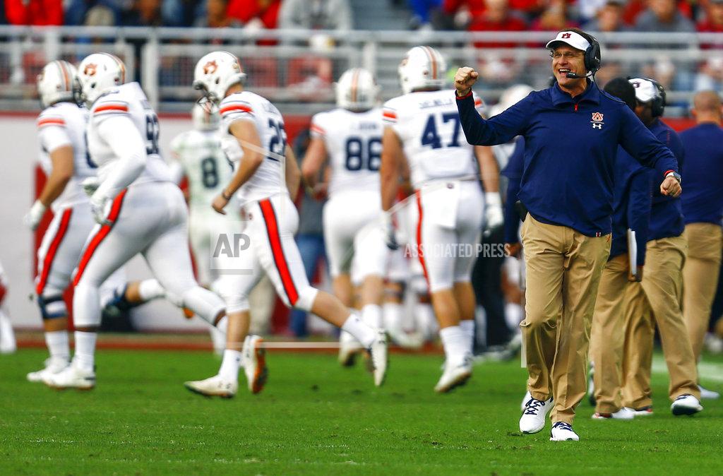 Butch Dill Auburn head coach Gus Malzahn, front right, reacts after his team scored a touchdown against Alabama during the first half of an NCAA college football game, Saturday, Nov. 24, 2018, in Tuscaloosa, Ala. (AP Photo/Butch Dill)