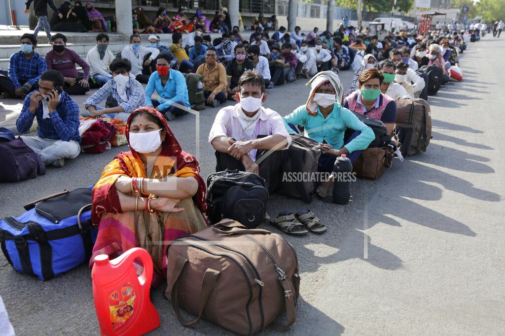 Ajit Solanki Migrant workers from other states trying to return to their homes wait for transportation to a train station in Ahmedabad, India, Sunday, May 17, 2020. Tens of thousands of migrant laborers have been returning from big cities to their villages after losing jobs because of a countrywide lockdown imposed in late March to contain the spread of the coronavirus. (AP Photo/Ajit Solanki)