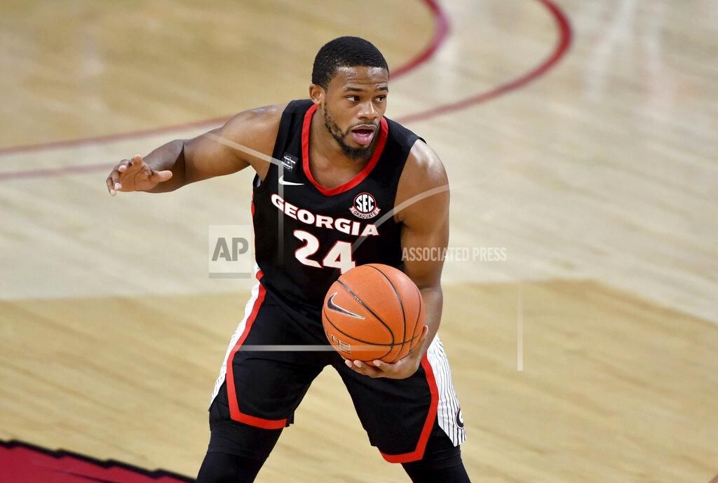 Michael Woods FILE - In this Jan. 9, 2021, file photo, Georgia's P.J. Horne (24) works with the ball during the first half of the team's NCAA college basketball game against Arkansas in Fayetteville, Ark. Coach Tom Crean said Wednesday, Oct. 20, on Twitter that Horne, Georgia's only returning starter, will miss the season with a knee injury. (AP Photo/Michael Woods, File)