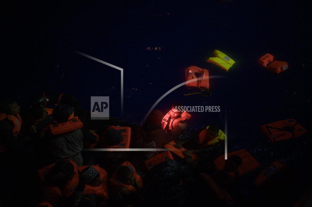 Valeria Ferrario Dozens of migrants swim toward rescuers after their boat upturned off the waters of Tunisia early Wednesday, May 25, 2022. Some 110 people were rescued by the non-governmental organization Open Arms during a mission in the Mediterranean Sea. (AP Photo/Valeria Ferraro)