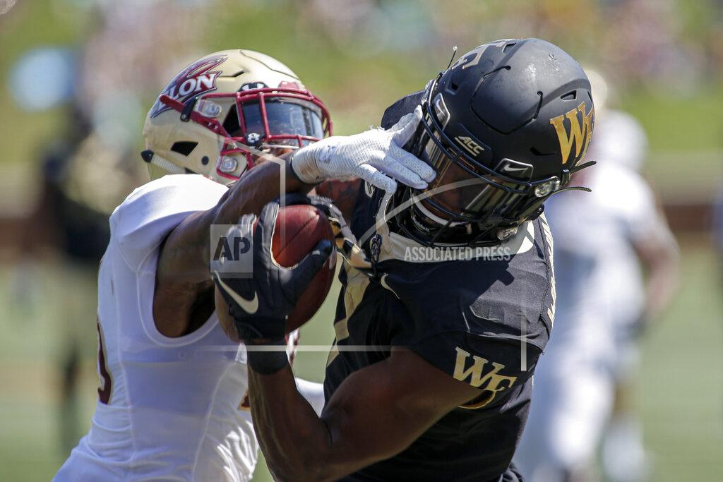 Nell Redmond Wake Forest wide receiver Scotty Washington, right, catches a 31-yard touchdown pass against Elon defensive back Daniel Reid-Bennett in the second half of an NCAA college football game in Winston-Salem, N.C., Saturday, Sept. 21, 2019. Wake Forest won 49-7. (AP Photo/Nell Redmond)