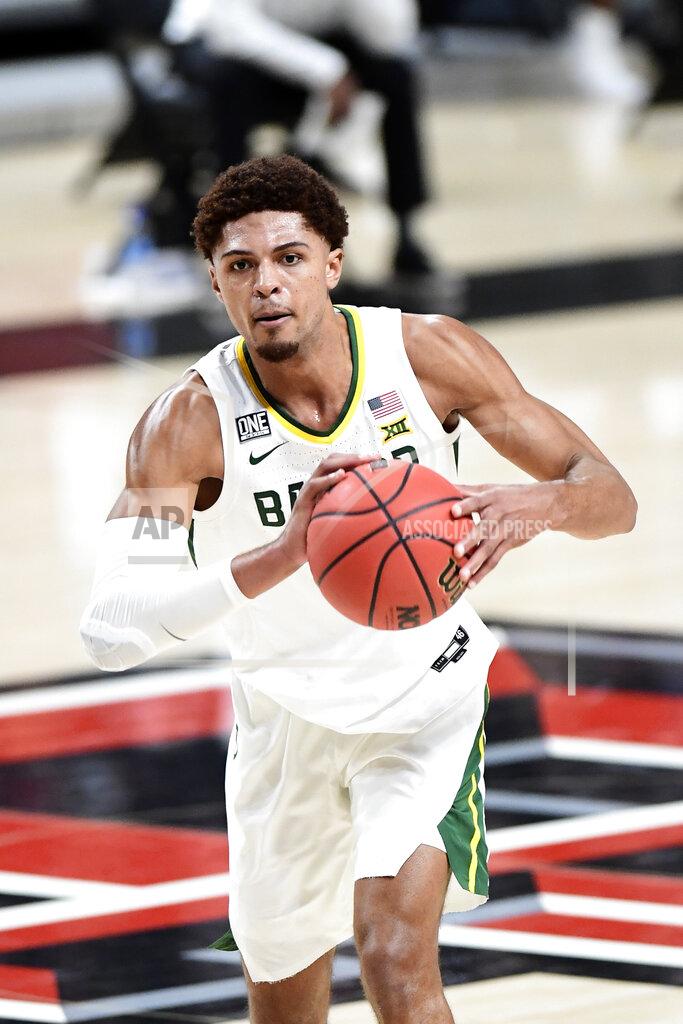 Justin Rex Baylor's MaCio Teague (31) passes the ball during the first half of an NCAA college basketball game against Texas Tech in Lubbock, Texas, Saturday, Jan. 16, 2021. (AP Photo/Justin Rex)