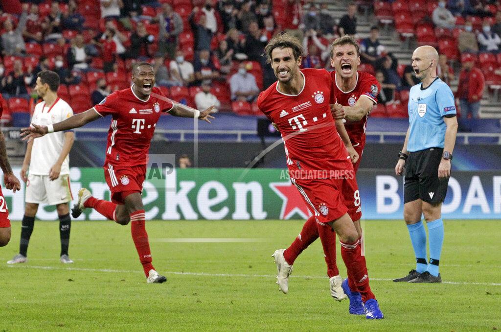 Bernadett Szabo Bayern's Javi Martinez, center, celebrates with teammates after scoring his side's second goal during the UEFA Super Cup soccer match between Bayern Munich and Sevilla at the Puskas Arena in Budapest, Hungary, Thursday, Sept. 24, 2020. (Bernadett Szabo/Pool via AP)