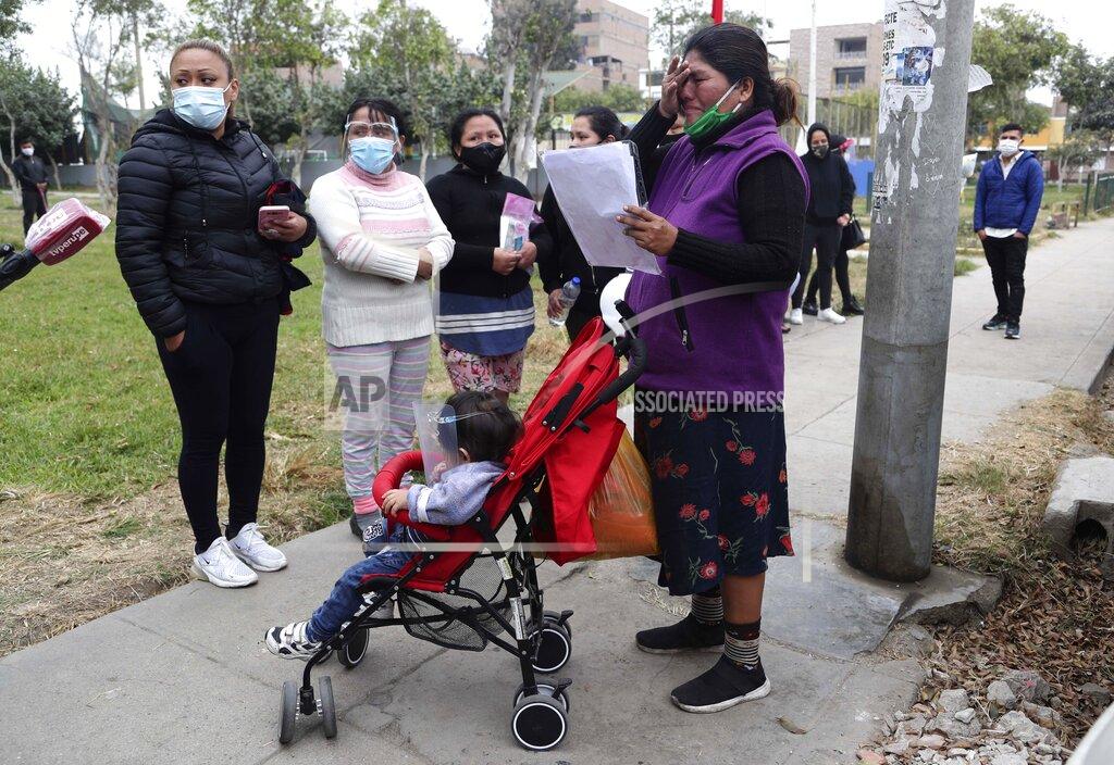 Martin Mejia Relatives wait for news of their relatives after a stampede at a disco, outside of a police station in Lima, Peru, Sunday, Aug. 23, 2020. Officials said over a dozen people died in a stampede at a disco in Peru after a police raid to enforce the country's lockdown during the coronavirus pandemic. (AP Photo/Martin Mejia)