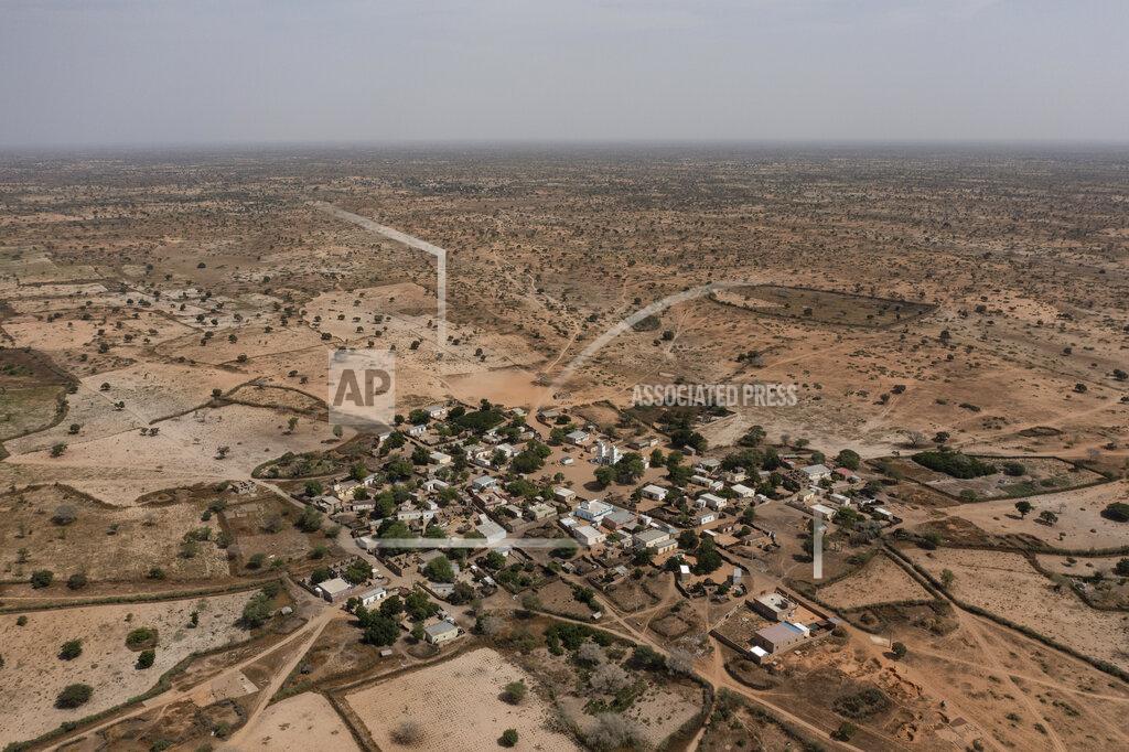 Leo Correa FILE - A desolate, semi-arid landscape surrounds the Sahel village of Ndiawagne Fall, on one end of a project called "Great Green Wall" that was envisioned as a way for Africa to fight climate change, in Kebemer, Senegal, Nov. 5, 2021. A series of complex challenges, including a lack of funding and political will as well as rising insecurity linked to extremist groups al-Qaida and the Islamic State in Burkina Faso, are obstructing progress on Africa's Great Green Wall, according to experts involved in the initiative. (AP Photo/Leo Correa, File)