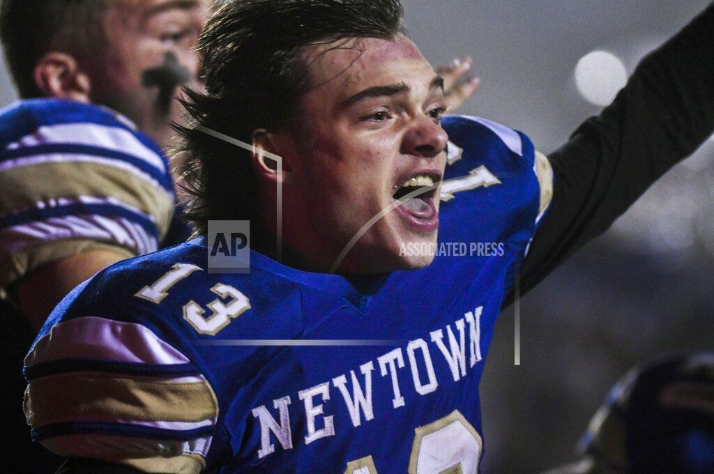Kassi Jackson Newtown's Riley Ward (13) reacts and looks back at his teammates after scoring the winning touchdown as the Newtown Nighthawks beat the Darien Blue Wave in the final play of the Class LL state football championship at Trumbull High School Saturday, Dec. 14, 2019, in Trumbull, Conn. Newtown won 13-7. Newtown marked the seventh anniversary of the massacre at Sandy Hook Elementary School with vigils, church services and a moment of joy when the community's high school football team, with a shooting victim's brother as linebacker, won the state championship Saturday in a last-minute thrill. (Kassi Jackson/Hartford Courant via AP)
