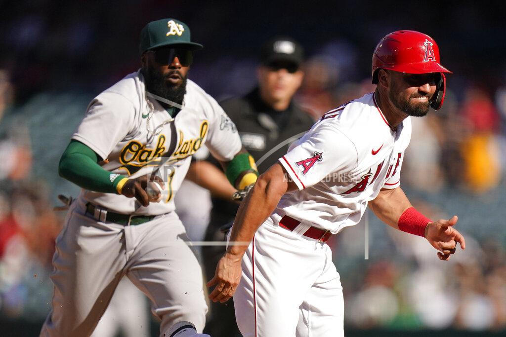 Jae C. Hong Oakland Athletics' Josh Harrison, background left, chases Los Angeles Angels' Jack Mayfield to tag him out during the 10th inning of a baseball game Sunday, Sept. 19, 2021, in Anaheim, Calif. (AP Photo/Jae C. Hong)