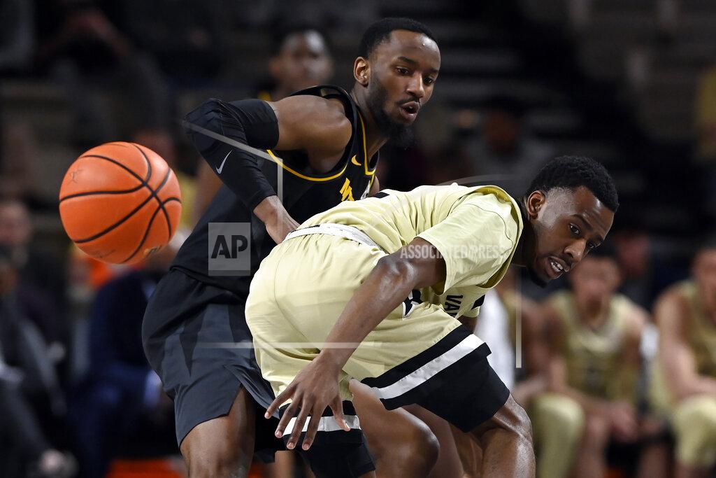 Mark Zaleski Vanderbilt guard Trey Thomas, right, loses control of the ball as he is defended by Missouri guard Amari Davis during the second half of an NCAA college basketball game Tuesday, Feb. 8, 2022, in Nashville, Tenn. Vanderbilt won 70-62. (AP Photo/Mark Zaleski)