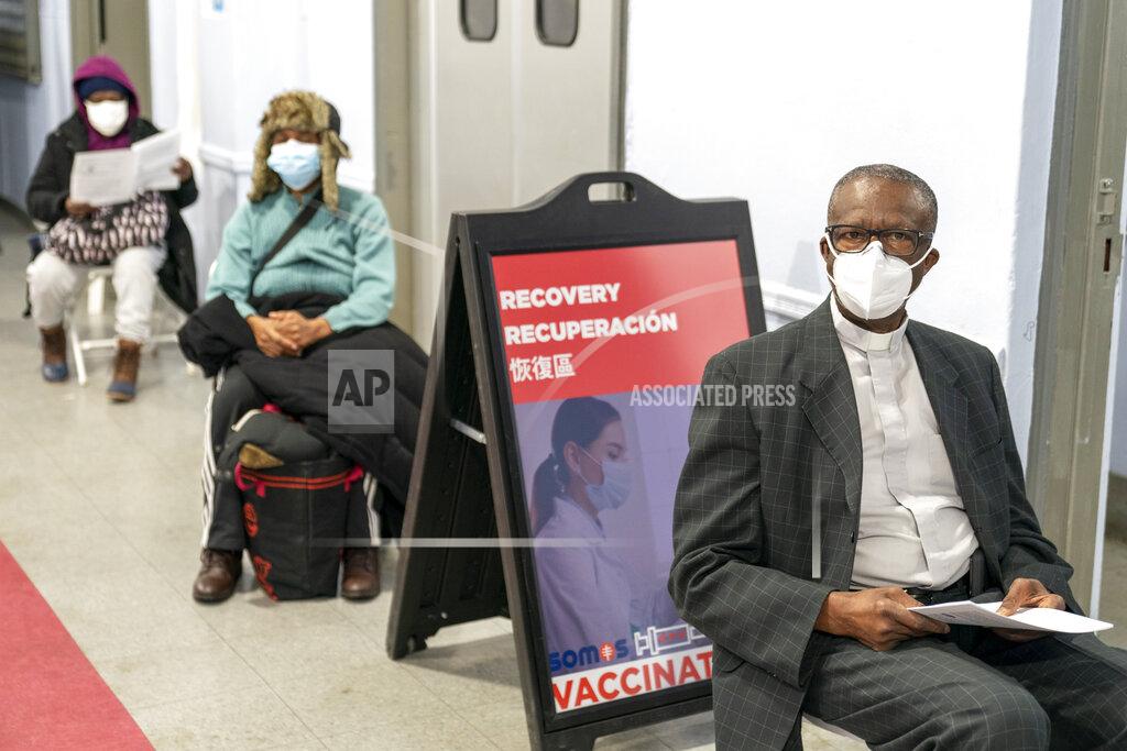 Mary Altaffer The Rev. Dr. Alfred Cockfield, Pastor God's Battalion of Prayer Church sits in the recovery area after receiving the first dose of the COVID-19 vaccine at a pop-up COVID-19 vaccination site at the church, Wednesday, Feb. 3, 2021, in the Brooklyn borough of New York. Rev. Cockfield and First Lady Linette received the vaccine in a public show of trust and faith in the vaccine. (AP Photo/Mary Altaffer)