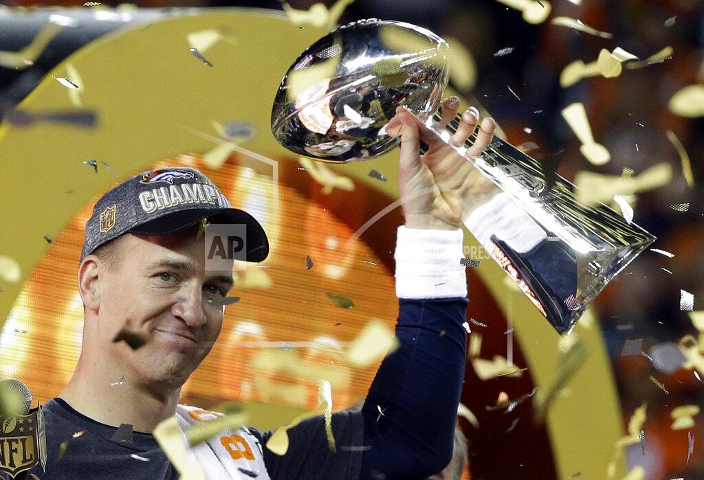 FILE - In this Feb. 7, 2016, file photo, Denver Broncos quarterback Peyton Manning holds up the Vince Lombardi Trophy after the Broncos defeated the Carolina Panthers 24-10 in NFL football's Super Bowl 50 in Santa Clara, Calif. Manning's legacy lives on at Empower Field at Mile High, where he will be honored Sunday, Nov. 1, 2021, during pregame and halftime ceremonies for his inductions into the Pro Football Hall of Fame and the Broncos' Ring of Fame.Fame and the Broncos' Ring of Fame. (AP Photo/Julie Jacobson, File)