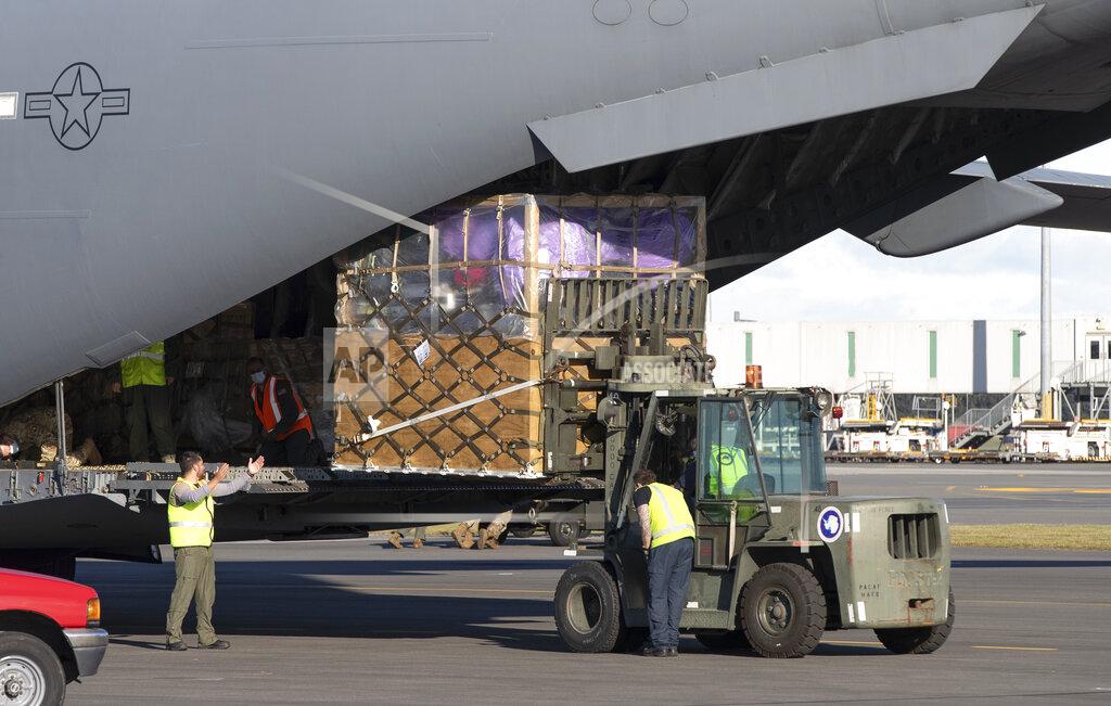 Mark Baker Ground crew load cargo onto a U.S. Air Force C-17 as they prepare to take the season's first flight to McMurdo Station in Antarctica from Christchurch Airport, New Zealand, Monday, Sept. 14, 2020. The first U.S. flight into Antarctica following months of winter darkness left from New Zealand Monday with crews extra vigilant about keeping out the coronavirus. (AP Photo/Mark Baker)