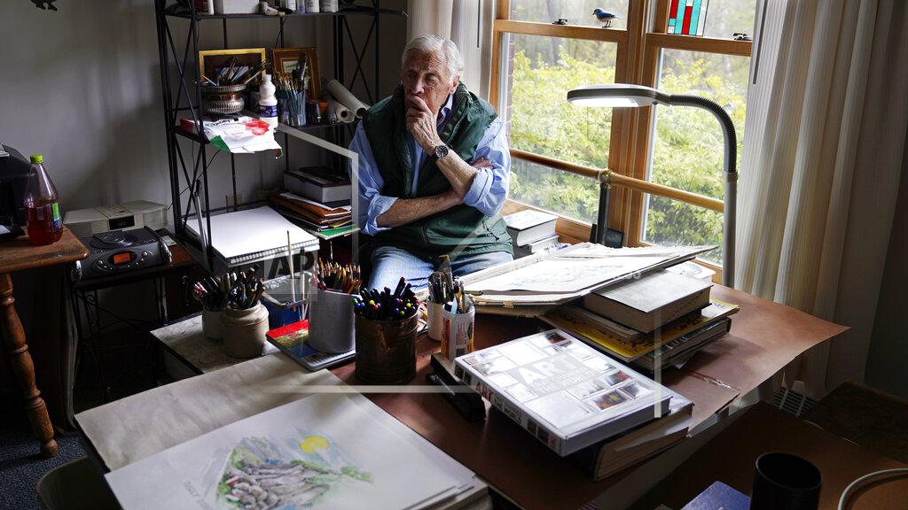 Charles Krupa Artist Robert Seaman pauses while sketching in his room at an assisted living facility Monday, May 10, 2021, in Westmoreland, N.H. Seaman, who moved into the facility weeks before the COVID-19 pandemic shutdown his outside world in 2020, recently completed his 365th daily sketch, or what he calls his "Covid Doodles", since being isolated due to the virus outbreak. (AP Photo/Charles Krupa)