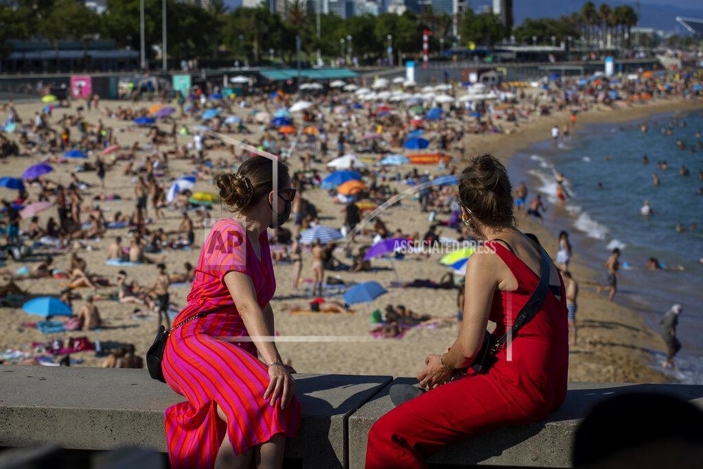 Emilio Morenatti Two women look at the beach in Barcelona, Spain, Saturday, July 18, 2020. Police in Barcelona are closing access to a large area of the city's beaches due to the excess of sunbathers who decided to ignore the urgings of authorities to stay at home amid a resurgence of the coronavirus. (AP Photo/Emilio Morenatti)