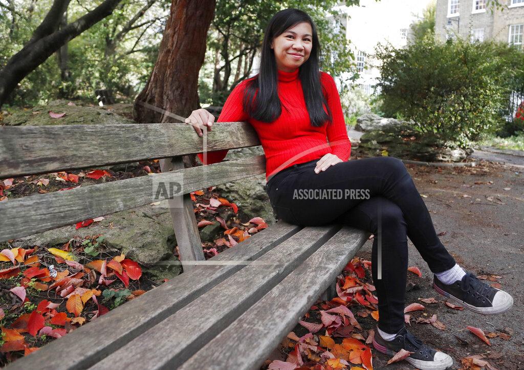 Frank Augstein Danica Marcos, sits in a park in London, Friday, Oct. 16, 202. Danica Marcos a volunteer as U.K. researchers are preparing to begin a controversial experiment that will infect healthy volunteers with the new coronavirus to study the disease in hopes of speeding up development of a vaccine. (AP Photo/Frank Augstein)