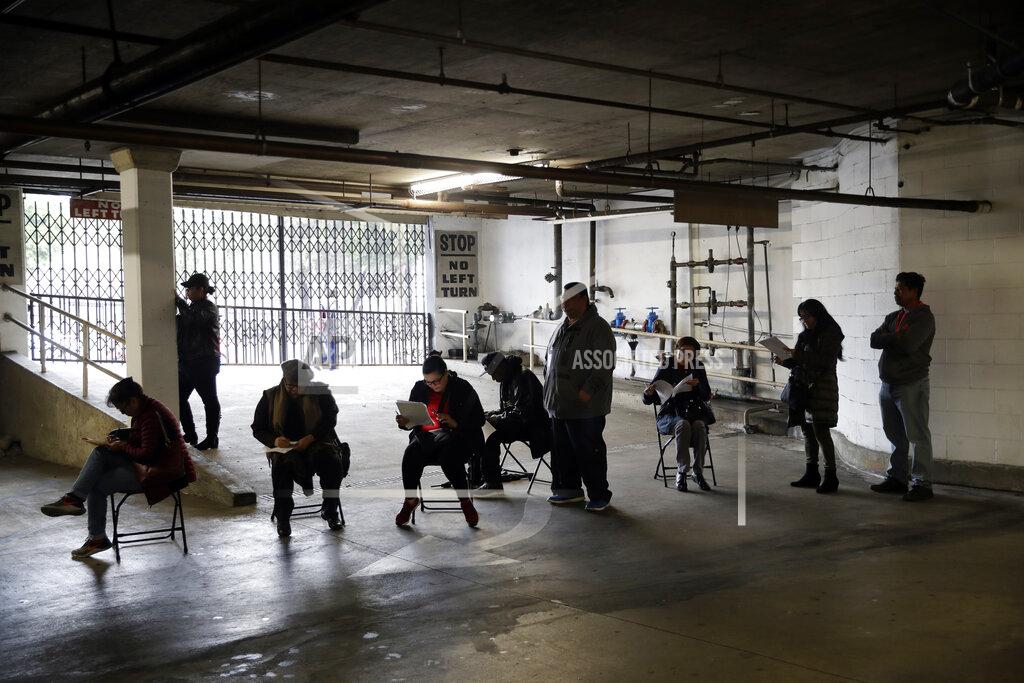 Marcio Jose Sanchez FILE - In this March 13, 2020, file photo, unionized hospitality workers wait in line in a basement garage to apply for unemployment benefits at the Hospitality Training Academy in Los Angeles. California lawmakers on Thursday, April 8, 2021, advanced what they called commonsense legislation requiring two state agencies to share information aimed at helping stop billions of dollars in pandemic-related unemployment fraud. (AP Photo/Marcio Jose Sanchez, File)