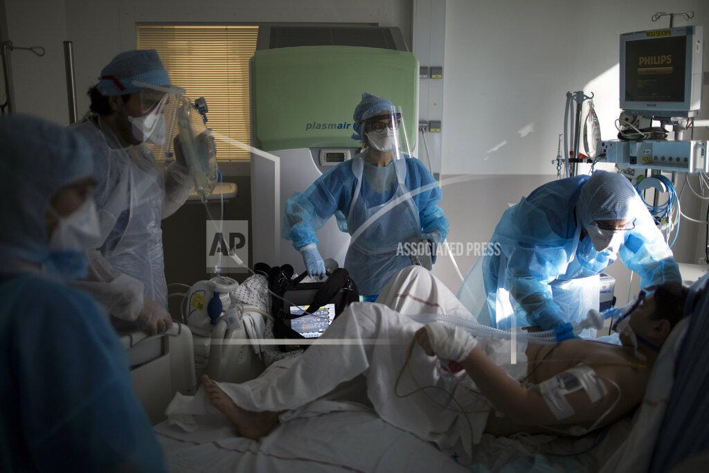 Daniel Cole Nurses transfer a sixteen-year-old patient suffering from COVID-19 into the ICU at the La Timone hospital in Marseille, southern France, Tuesday Feb. 2, 2021. COVID patients occupy 88% of the Marseille region's intensive care beds, and virus pressure on French hospitals is steadily rising in recent weeks despite curfews and other restrictions. (AP Photo/Daniel Cole)