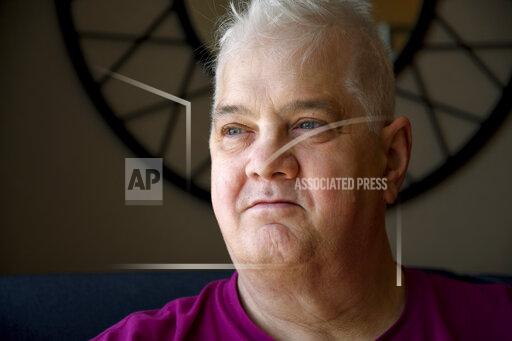 Dana Zzyym poses for a photo, Wednesday, Oct. 27, 2021, in Fort Collins, Colo. Zzyym, who prefers a gender-neutral pronoun, told the Associated Press that their passport is the first U.S. passport to be issued with an "X" gender designation, marking a milestone in the recognition of the rights of people who do not identify as male or female. (AP Photo/Thomas Peipert)
