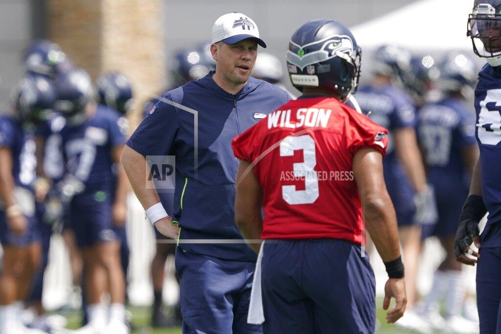 Ted S. Warren FILE - In this July 28, 2021, file photo, Seattle Seahawks offensive coordinator Shane Waldron, left, talks with quarterback Russell Wilson during NFL football practice in Renton, Wash. Of all the offseason moves made by the Seattle Seahawks none may end up being more important than hiring Waldron as offensive coordinator. Tasked with modernizing Seattle's offense and making Russell Wilson happy, Waldron's system finally gets its unveiling in the opener on Sunday against Indianapolis.(AP Photo/Ted S. Warren, File)