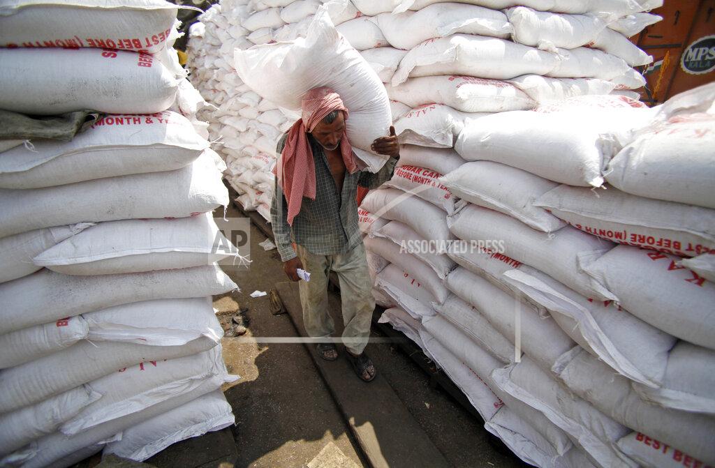 Channi Anand FILE- A laborer carries a sack of sugar at a warehouse in Jammu, India, Thursday, Aug. 22, 2013. India is restricting sugar exports to 10 million tons in the current season in 2022 to help maintain domestic availability and keep prices stable. India is the second-largest producer, after Brazil, and biggest consumer of sugar in the world, according to the All India Sugar Trade Association. It's the second-largest exporter of sugar. (AP Photo/Channi Anand, File)
