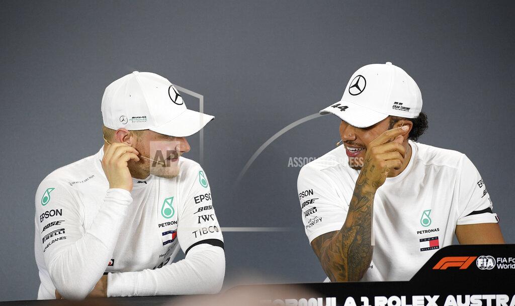 Mercedes drivers Lewis Hamilton of Britain, right, and Valtteri Bottas of Finland attend a press conference after qualifying for the Australian Grand Prix in Melbourne, Australia, Saturday, March 16, 2019. Hamilton qualified first and Bottas second place on the grid for the first race of the year, Sunday. (AP Photo/Andy Brownbill)