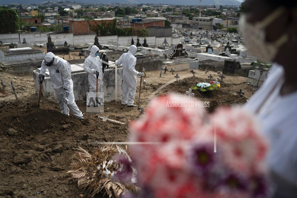 Leo Correa Cemetery workers wearing hazmat suits complete the burial of Ana Maria, a 56-year-old nursing assistant who died from the new coronavirus, in Rio de Janeiro, Brazil, Tuesday, April 28, 2020. Ana Maria's daughter Taina dos Santos said that the situation in the Salgado Filho public hospital where her mother worked is complicated and that some health workers have to buy their own protective gear. "She gave everything to her job until the very end," said the 27-year-old daughter. (AP Photo/Leo Correa)