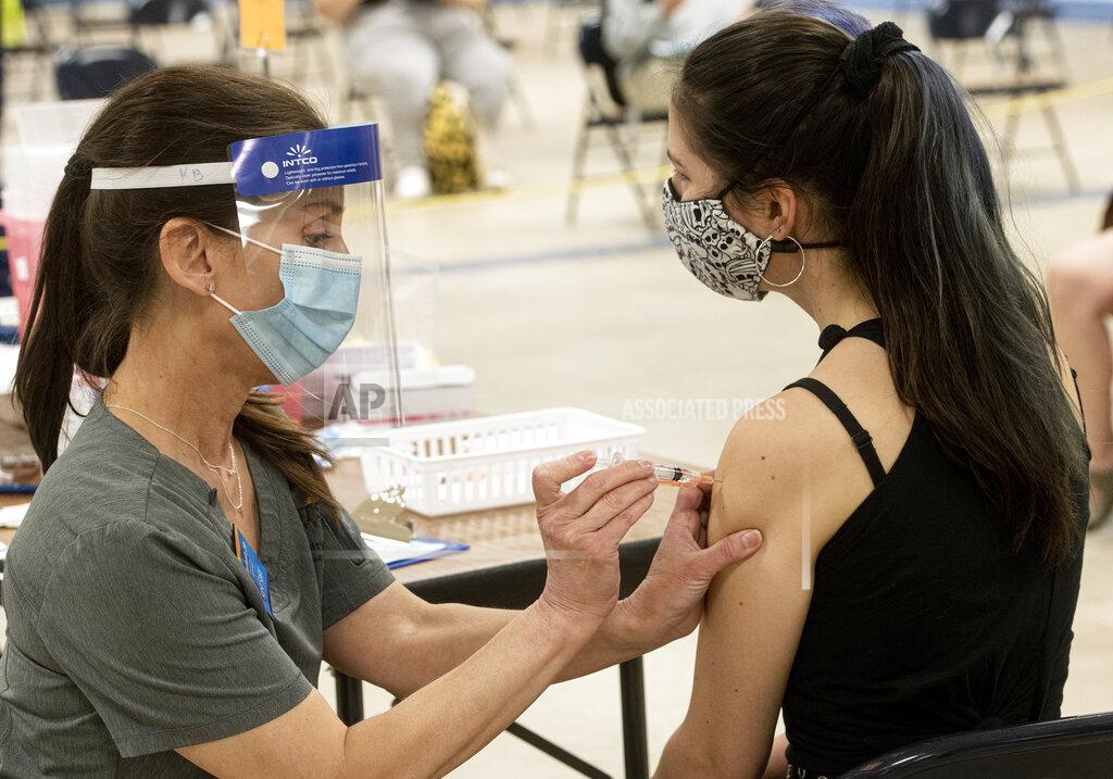 Phil Long FILE-This Thursday, April 8, 2021 file photo shows Kent State University student Regan Raeth of Hudson, Ohio, has her COVID-19 vaccination administered by Kent State nurse Kristen Barath in Kent, Ohio. The nation's largest traditional supermarket chain and some college campuses are among the Ohio providers that temporarily stopped using the Johnson & Johnson coronavirus vaccine Tuesday, April 13, while federal officials investigate reports of potentially dangerous blood clots. Kent State University said it was postponing its J&J clinics until further notice. (AP Photo/Phil Long, File)