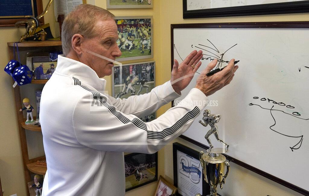 David J. Phillip Marist School football coach Alan Chadwick talks about a touchdown play Los Angeles Rams coach Sean McVay ran in high school during an interview for the NFL Super Bowl 53 football game Friday, Feb. 1, 2019, in Atlanta. McVay was the starting quarterback his senior year at Marist when the team won the state championship in 2003. (AP Photo/David J. Phillip)