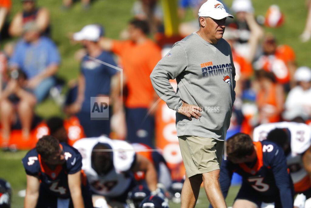Denver Broncos head coach Vic Fangio looks on as players stretch before drills at the team's NFL football training camp Friday, July 19, 2019, in Englewood, Colo. (AP Photo/David Zalubowski)