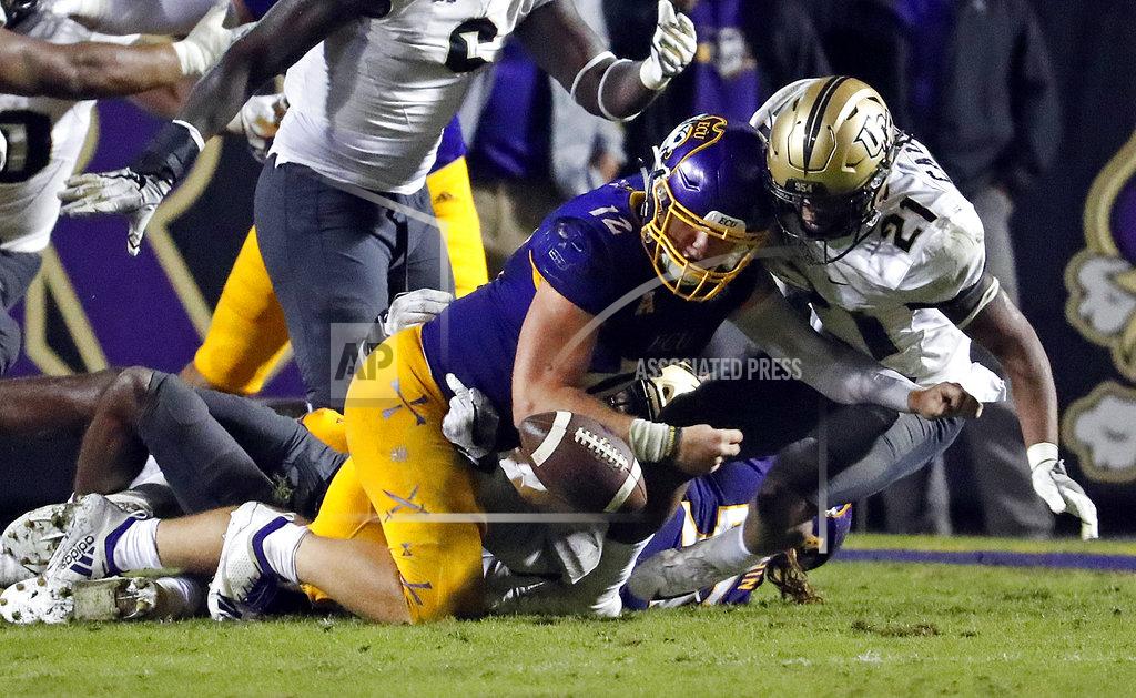 Karl B Deblaker East Carolina's Holton Ahlers (12) is stopped from recovering his fumble by Central Florida's Rashard Causey (21) during the second half of an NCAA college football game in Greenville, N.C., Saturday, Oct. 20, 2018. UCF won 37-10. (AP Photo/Karl B DeBlaker)