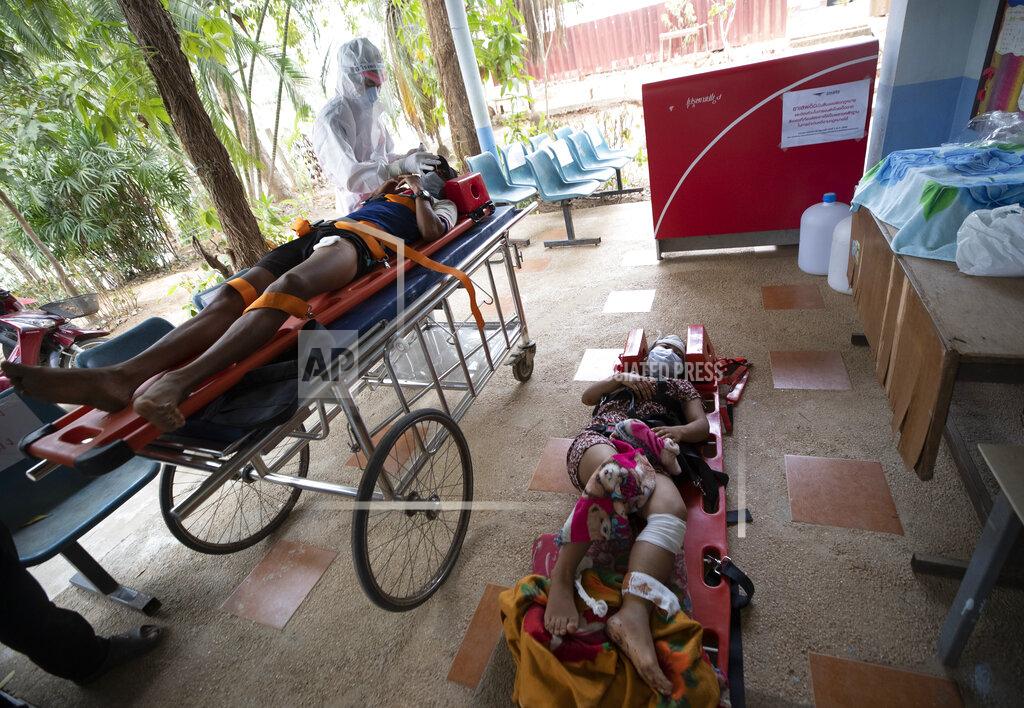 Sakchai Lalit Ethnic Karen villagers from Myanmar rest on stretchers as they arrive at Ban Mae Sam Laep Health Center, Mae Hong Son province, Thailand on Tuesday March 30, 2021. The weekend strikes by the Myanmar military, which sent ethnic people to seek safety in Thailand, represented another escalation in the violent crackdown by Myanmar’s junta on protests of its Feb. 1 takeover. (AP Photo/Sakchai Lalit)
