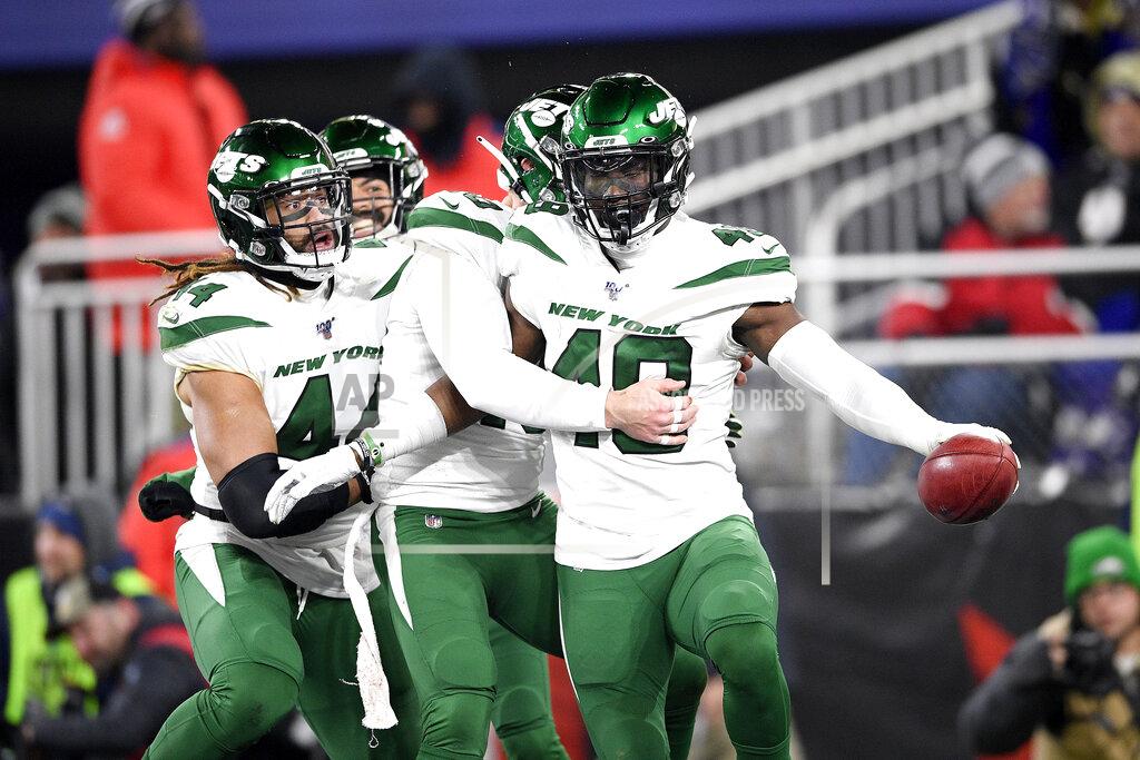 Nick Wass New York Jets players celebrate after linebacker B.J. Bello, right, returned a Baltimore Ravens blocked punt for a touchdown during the second half of an NFL football game, Thursday, Dec. 12, 2019, in Baltimore. (AP Photo/Nick Wass)